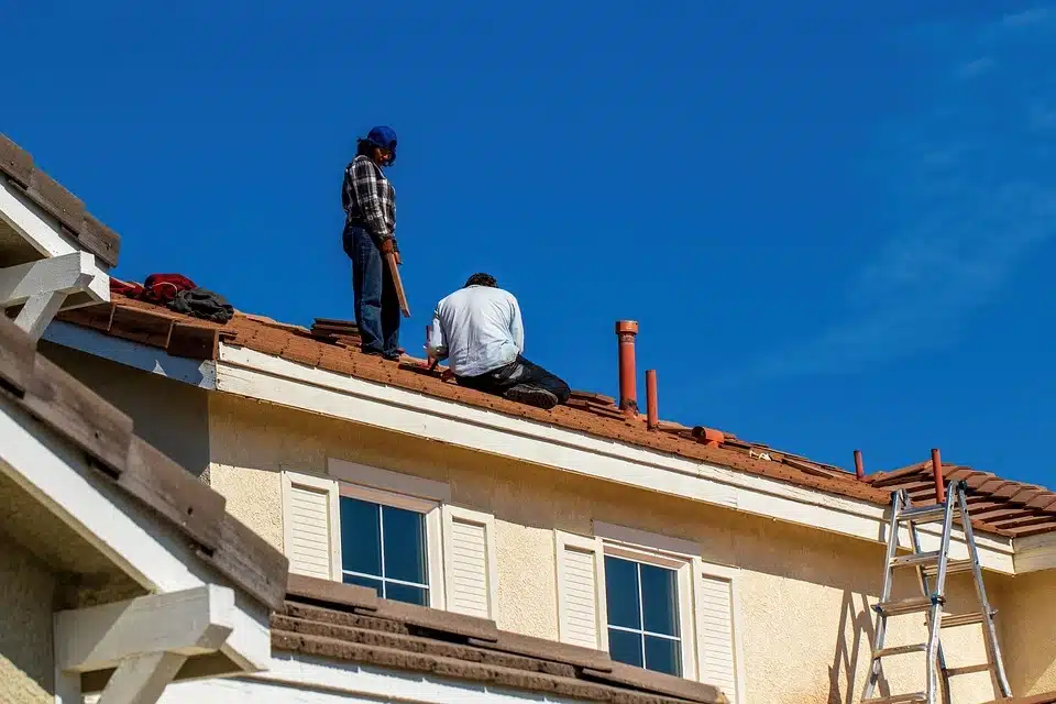 Man inspecting shingles on a residential Winnipeg roof as part of a smart roof inspection checklist.