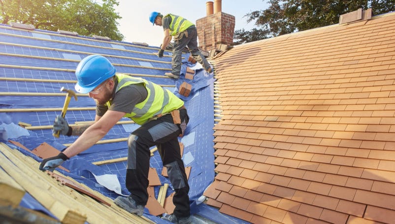 2 men fixing roofs
