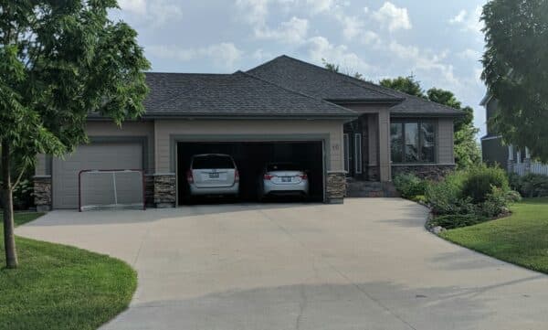 a house with new roof completed by All Weather Exteriors
