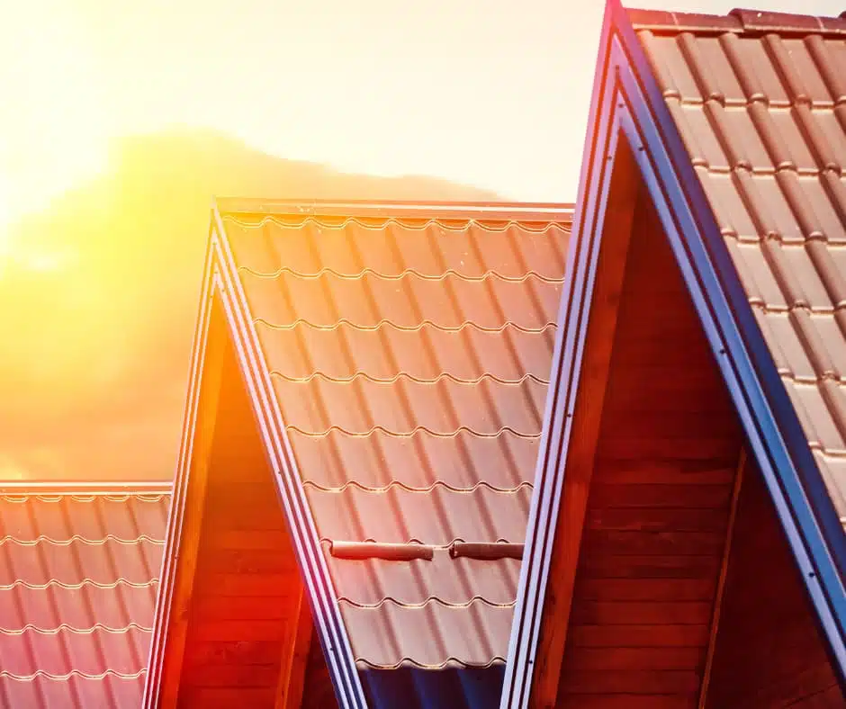 a group of roof tops with the sun shining through