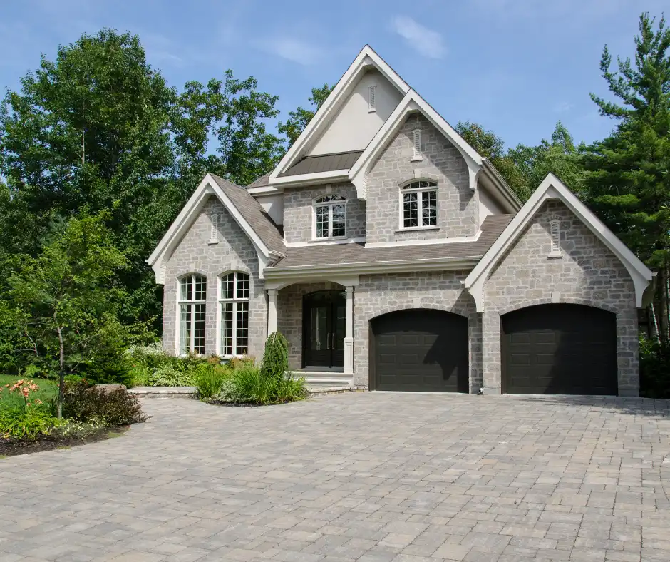 a house with a driveway and trees, example of roofing services in tuxedo