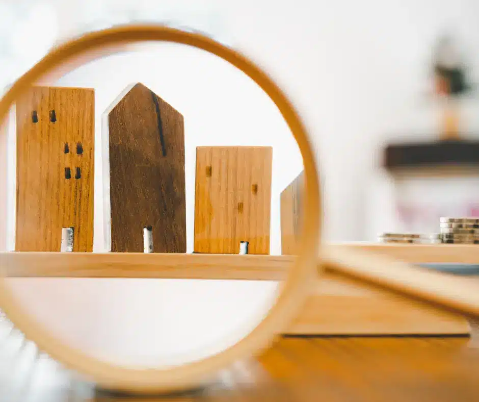 wooden house miniature seen in a magnifying glass
