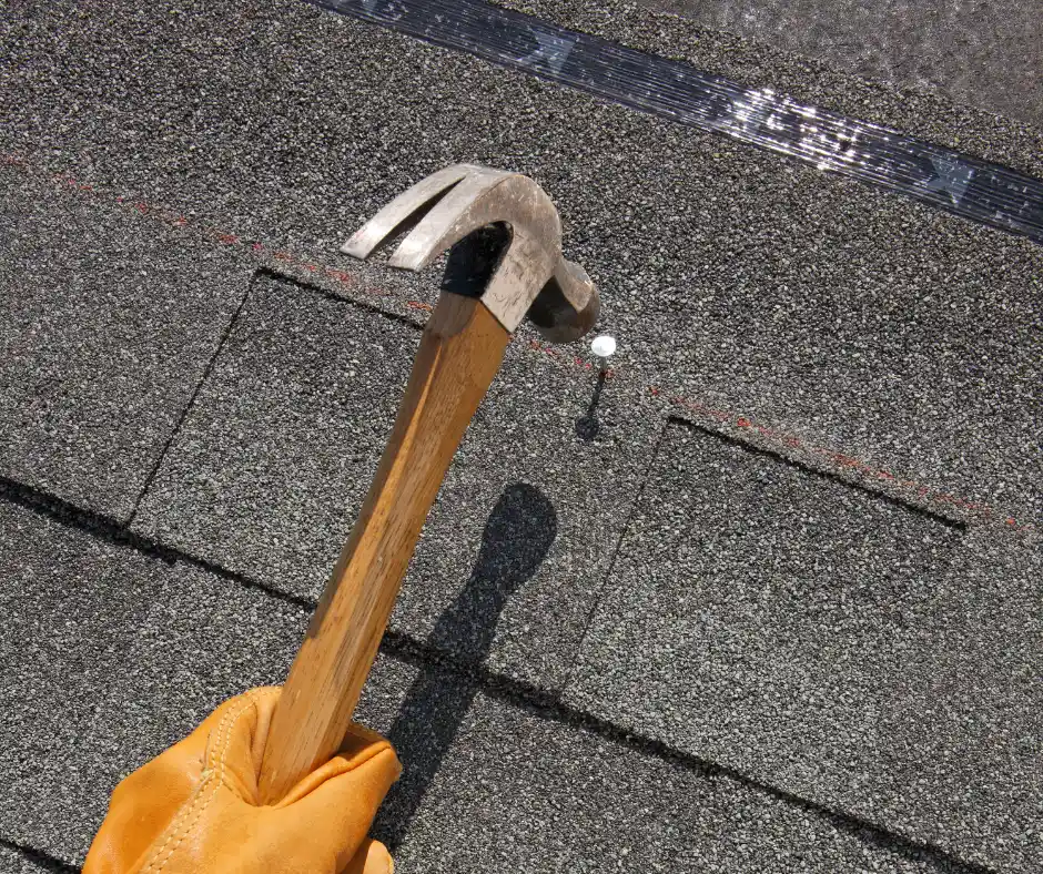 a hammer and nail on a roof