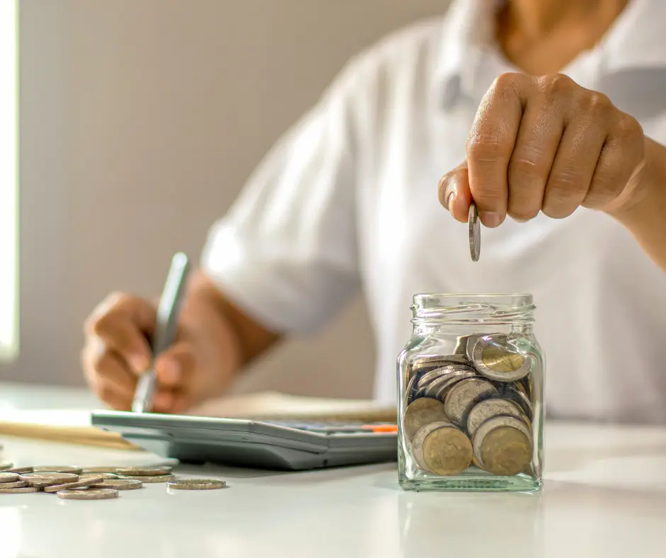 man putting coin in a piggy bank