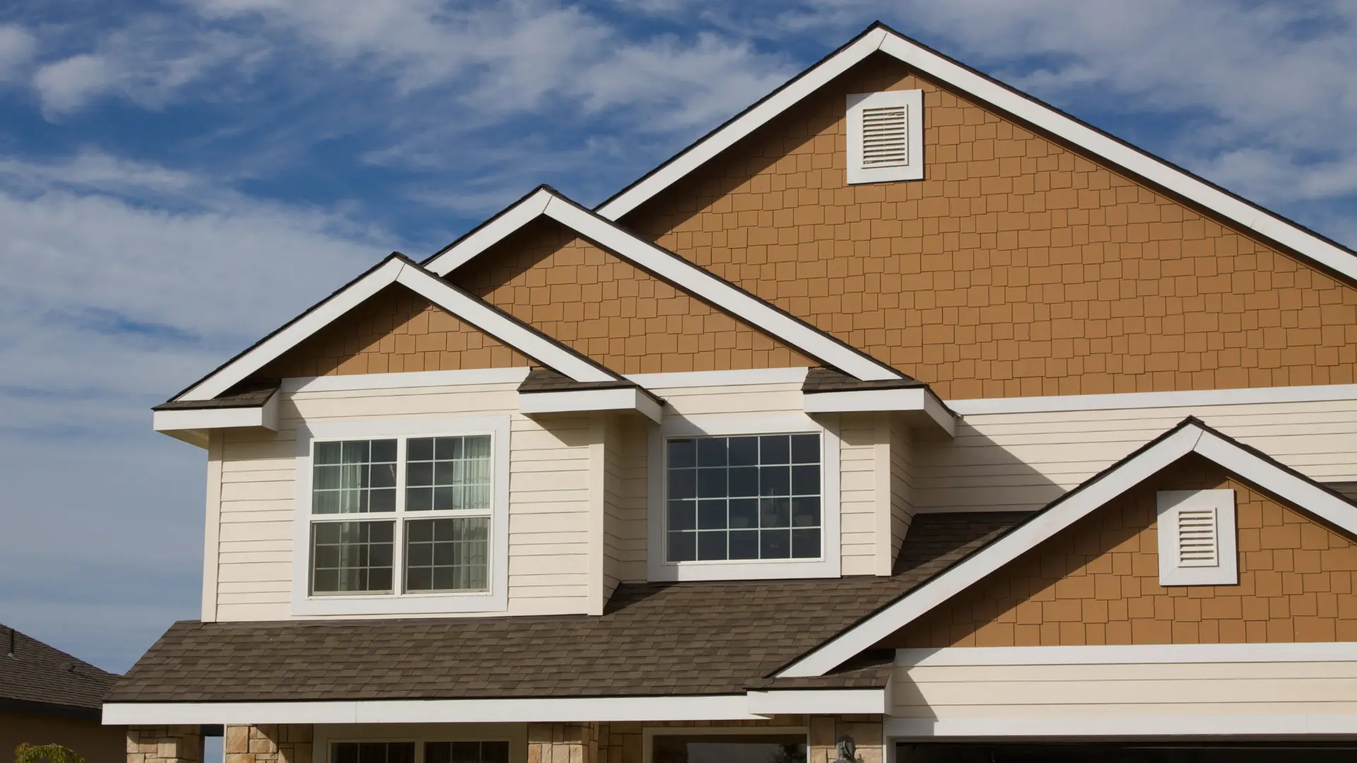 a house with a roof and a blue sky