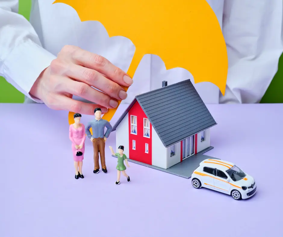 A person holds a paper umbrella over a miniature house, family figurines, and a toy car. This is possible if your roofer is properly insured
