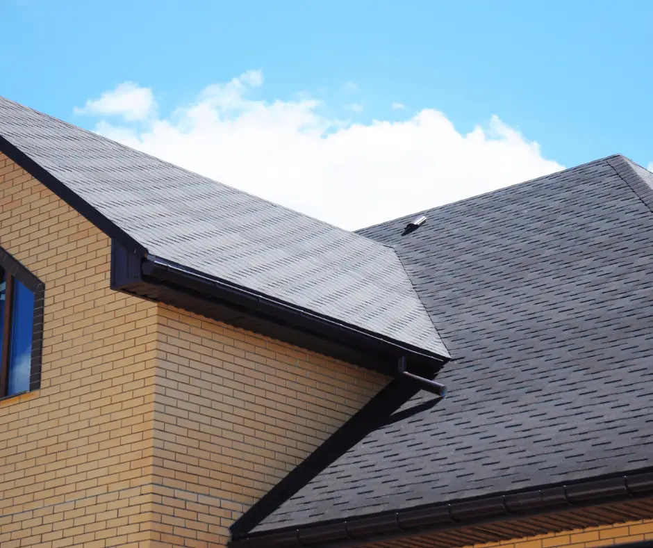 Modern home with dark asphalt shingle roof and brick siding.