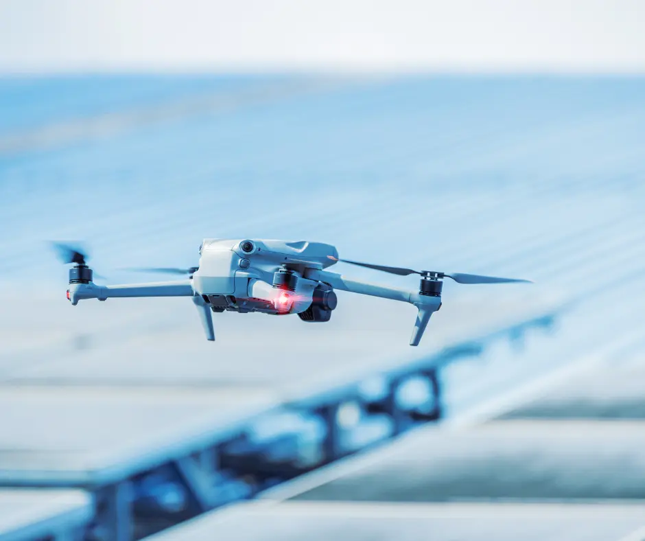 Small drone flying over a roof or large flat surface.