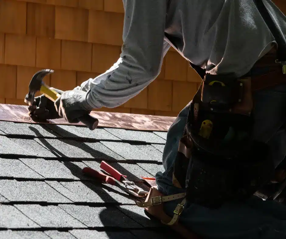Person repairing a roof with tools