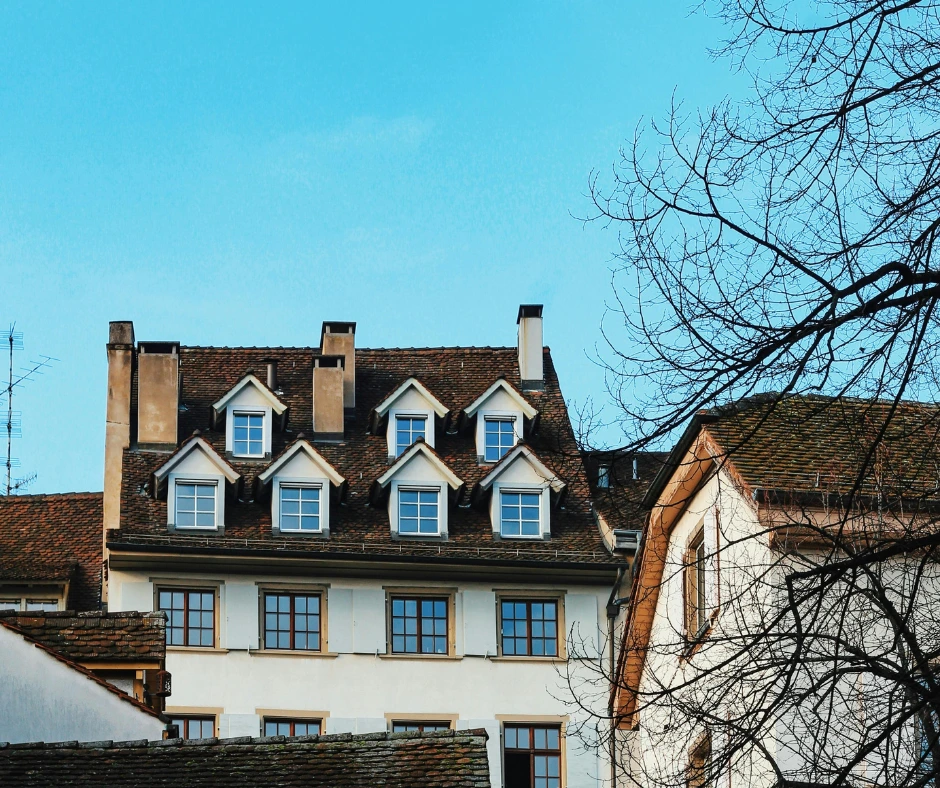 A multi-story building with high architectural complexity and several dormers, which can significantly increase a roof quote estimate.